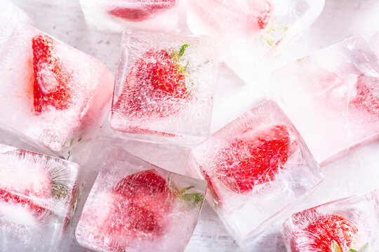Strawberries frozen in ice cubes - Top of view.