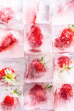 Three rows of ice cubes with strawberries - Top of view