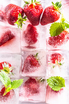 Three rows of ice cubes with strawberries - Top of view