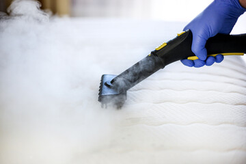 Cleaning and disinfection of the mattress in the bedroom with hot steam. Professional cleaning...