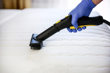 Cleaning and disinfection of the mattress in the bedroom with hot steam. Professional cleaning...