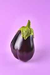 Eggplant on a purple background, fresh juicy vegetable on a colored background, selective focus,  close-up