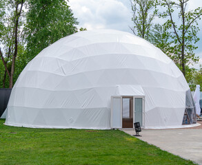 White mobile dome design. Outside spherical glamping dome. Hemispherical structure lattice shell...