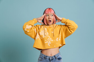 Asian girl with pink hair and piercing expressing surprise at camera - obrazy, fototapety, plakaty