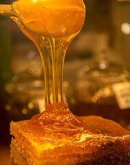 Transparent honey flows down the honeycomb