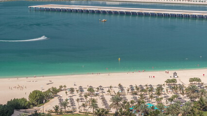The beach at JBR with golden sand near seaside aerial timelapse