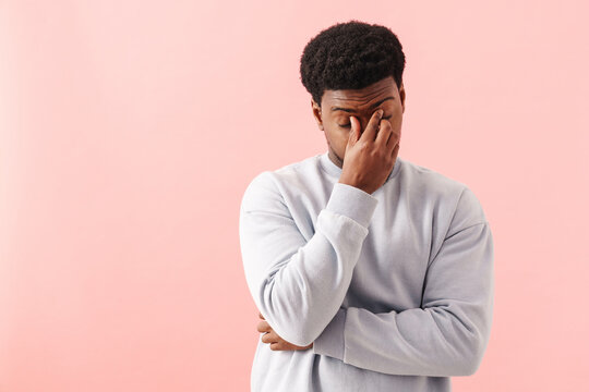 Black Tired Man Rubbing His Eyes While Posing On Camera