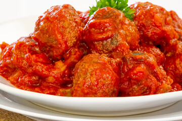close up of beef meatball in tomato sauce