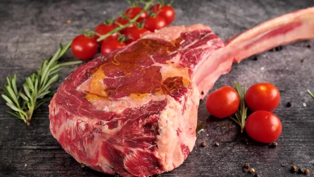 Tomahawk ribeye steak, Irish beef, drizzled with oil. High quality 4k footage