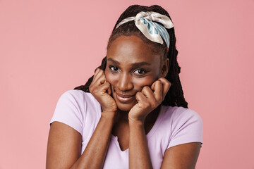 Young black woman wearing headband smiling and looking at camera