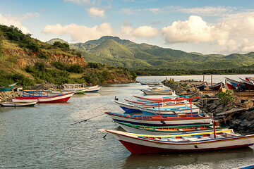 Fototapeta na wymiar Photographs of beaches of Margarita Nueva Esparta in the morning and at sunset. You can see mountains, sun, clouds, sun rays, sunset, beaches, ships, boats, people fishing, rocks, waves, mist,