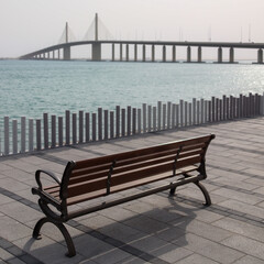 Fototapeta na wymiar Wooden bench on the beach walkway in Abu dhabi