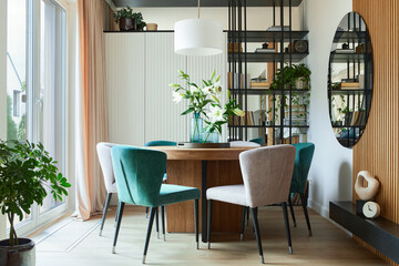 Stylish composition of elegant dining room interior design with velvet armchairs, design rouded...