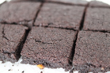 Flat lay composition with fresh brownies on parchment paper.