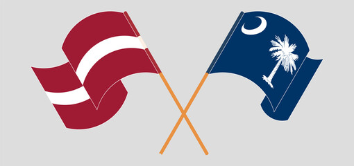Crossed and waving flags of Latvia and The State of South Carolina