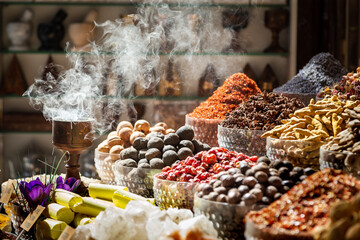 Arabic traditional incense bukhoor agar wood burner with the smoke, used in majlis, Ramadan and Eid in the spice market in Dubai