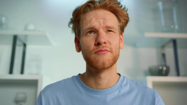 Software customer talking interview at home closeup. Ginger man doubting think