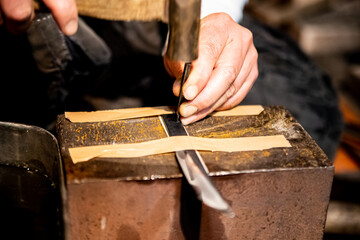 Carving a name into a metal blade of a Japanese katana samurai sword