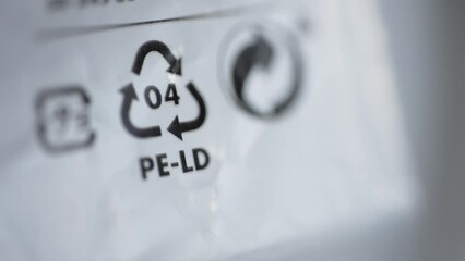 4k Close view of 4 LDPE recycling sign or label and others on white packaging spbd. Low density polyethylene is flexible plastic with many applications. Found in: squeezable bottles, bread, frozen