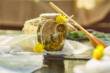 Natural organic tincture with fresh yellow wildflowers - dandelions. Homemade herbal organic...