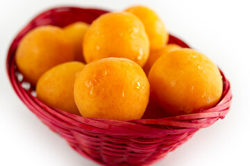 organic apricots in a pink basket