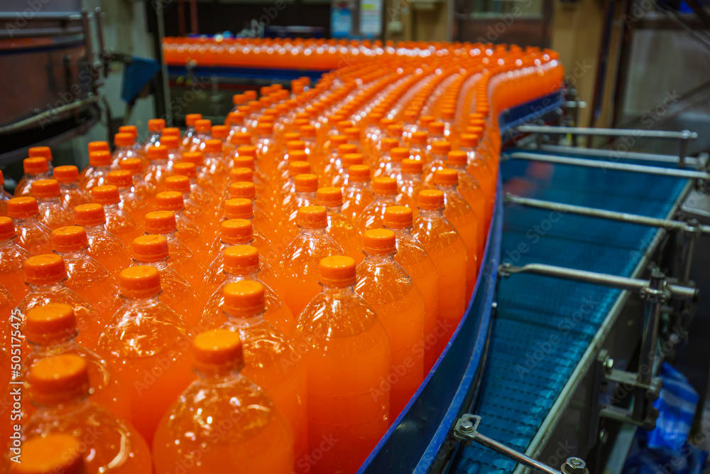 Wall mural beverage factory interior. conveyor flowing with bottles for juice