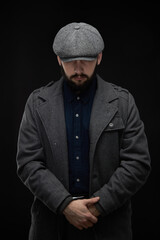 Man with a beard on a dark background, English classic clothes