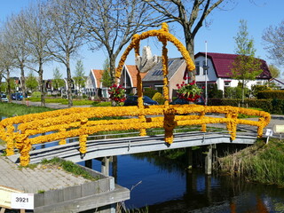 Bridge decorated with flowers during the Bloemendagen (Flower days) in spring at Anna Paulowna, North Holland, Netherlands