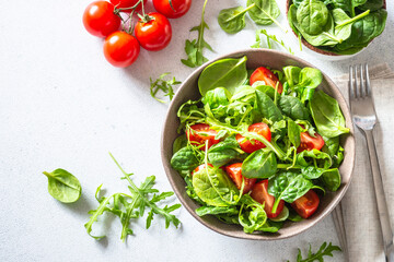 Green salad with fresh leaves and tomatoes.