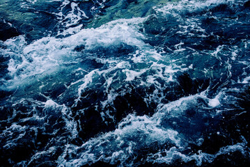 Dramatic sea waves storm from aerial view. Deep dark blue ocean water texture background. Top view....