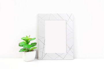Silvery frame with a flower on a white background