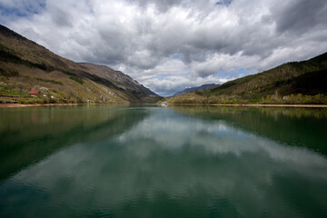 Cruise on the emerald waters of the Drina River and the picturesque cloudy sky reflected in it.