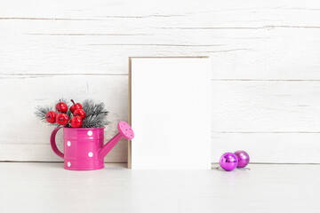 Envelope and invitation on the table with balls and fir branches.