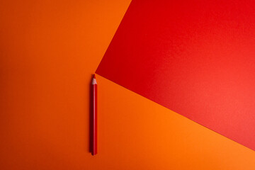 red pencil on orange background 