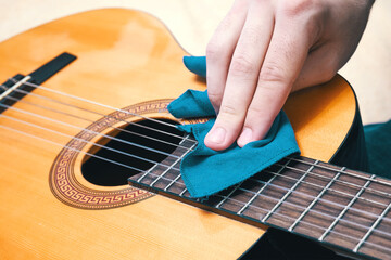 Cleaning the guitar. Musical instrument care. Proper guitar maintenance