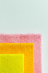 close up of yellow, orange and pink rags isolated on grey, top view.