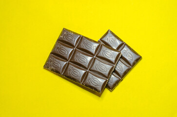 Dark chocolate on a yellow background