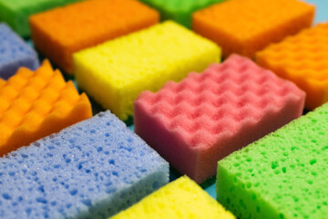 close up view of different multicolored washcloths on blurred background.