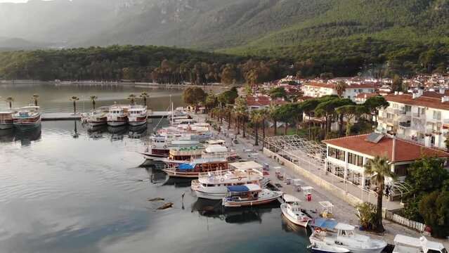 Aerial View Of The Harbor And The Buildings Of A Small Town Between The Sea And The Mountains