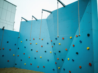 Climbing wall, blue climbing wall. Geometry both in the city and buildings.