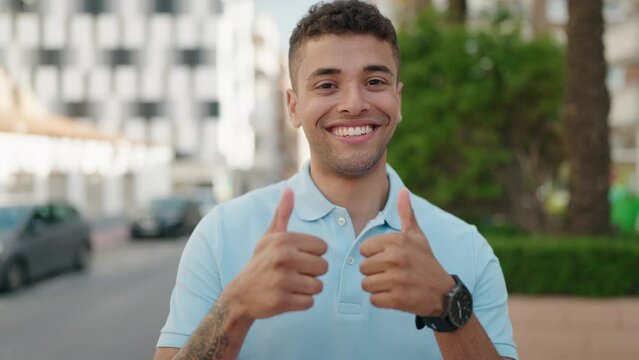 African american man smiling confident doing ok sign with thumbs up at park