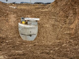 Dug-in concrete well rings with a concrete cover. Plumbing and sewerage.