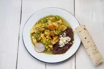 Egg with green sauce and refried beans. Mexican food