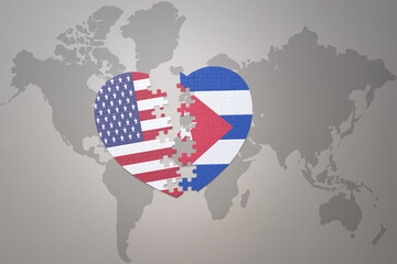 puzzle heart with the national flag of united states of america and cuba on a world map background. Concept.