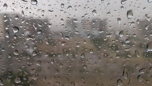 Raining drops on glass and lightening with sound