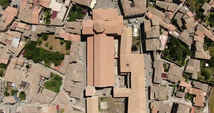 Gerace, Calabria, Italy. Aerial drone view. Slow descending flight with vertical view and tilting camera over the abbey.