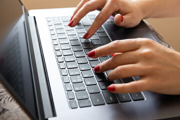 close up of female hands on a laptop keyboard. business concept