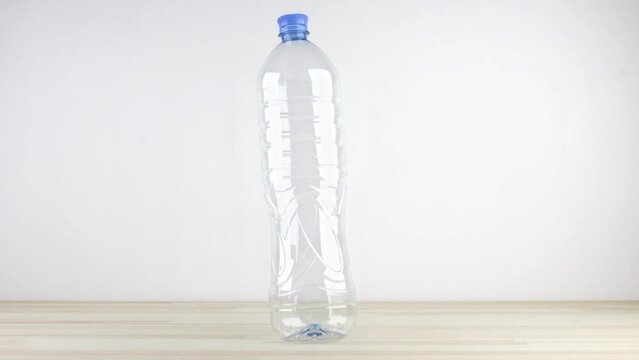 Stop-motion animated video of the proper way of recycling plastic bottles. It shows if the bottles are compressed the recycling container can fit much more of them. Tutorial loop video, eco concept.