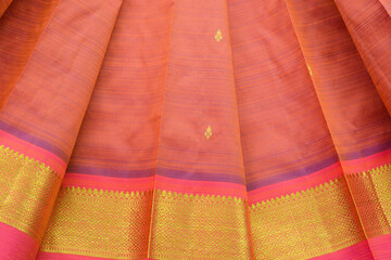 Orange silk sari with gold floral design border