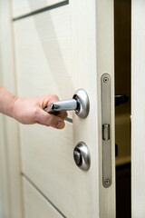 woman opening door. chrome door handle close-up.